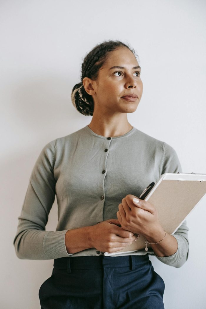 Woman holding papers on a clipboard